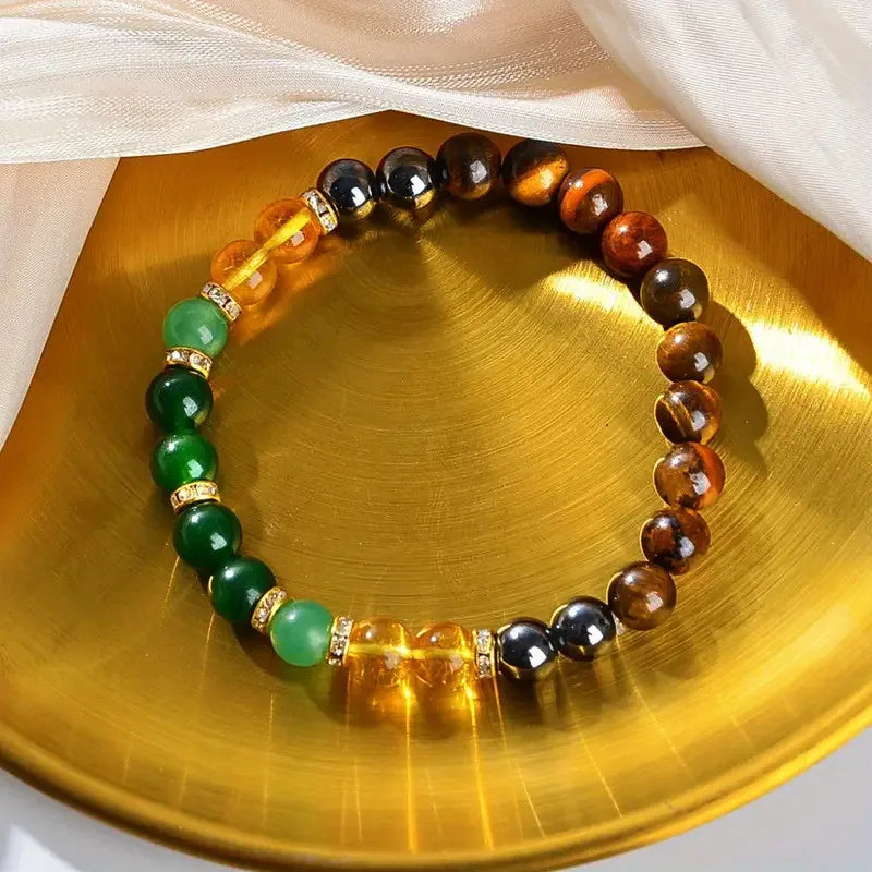 Handcrafted Chakra balancing protection bracelet displayed on a golden metal tray
