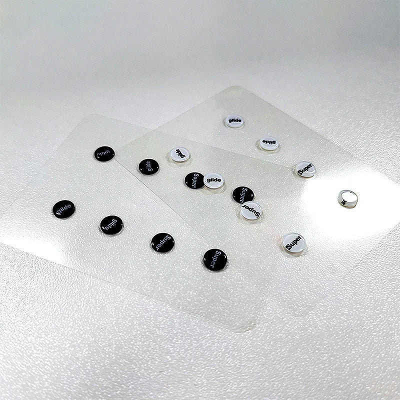 8-piece circular black glass mouse skate dots on clear protective sheet